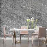Grey stone texture wallpaper creating depth in minimalist dining room setting
