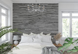 Stone wall mural creating dramatic backdrop in contemporary dining room