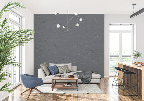 Modern grey slate stone wallpaper in a minimalist living room with natural lighting