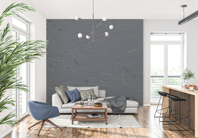 Modern grey slate stone wallpaper in a minimalist living room with natural lighting