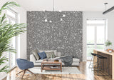 Speckled grey stone mural creating depth in a contemporary dining room