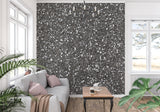 Grey speckled wall mural showcasing light reflection in an entrance hall