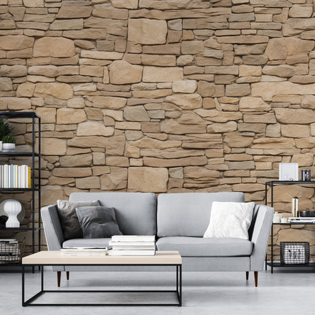 Stone effect wallpaper creating a natural beige accent wall in a modern living room with soft lighting and minimal furniture