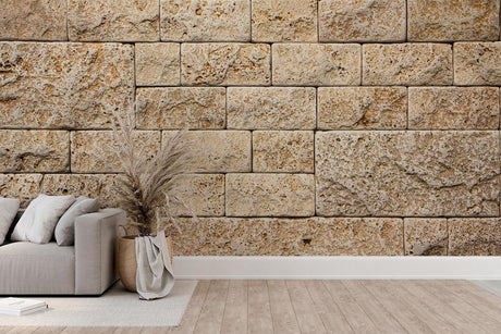 Stone block wallpaper creating a stunning accent wall in a modern living room with beige and natural tones