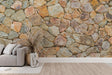 Stone wall mural creating a stunning accent wall in a modern living room with earth-toned furniture and natural light