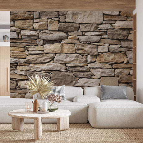 Stone effect wallpaper creating a stunning accent wall in modern living room with grey sofa and natural decor