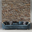Stone wall mural in modern living room showing textured beige and terracotta tones creating warm atmosphere