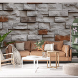 Stone brick wallpaper creating dramatic accent wall in modern living room with grey sofa and industrial lighting