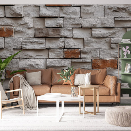 Stone brick wallpaper creating dramatic accent wall in modern living room with grey sofa and industrial lighting