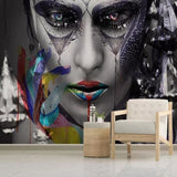 Street art face wallpaper creating bold impact in modern living room with grey sofa and minimal decor