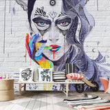 Street art mandala portrait wallpaper creating a bold statement wall in a modern living room with minimalist furniture