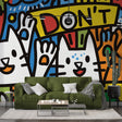 Street art cat wallpaper bringing modern style to a bright living room with colorful furniture and natural light
