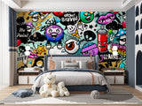 Street art graffiti wallpaper creating bold impact in modern teen bedroom with gaming setup