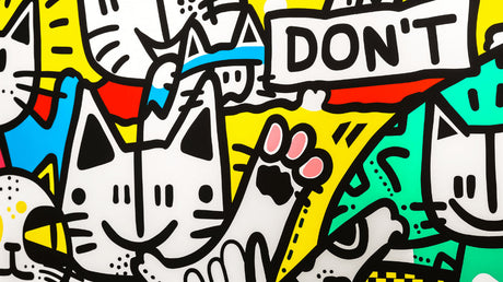 Street art cat wallpaper bringing urban style to a modern living room with white walls and minimal furniture