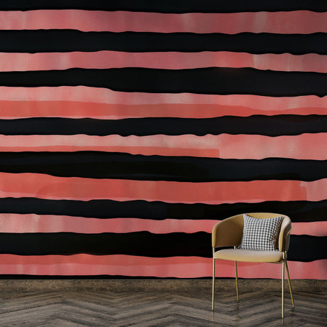 Modern striped wallpaper in coral and black creating a bold statement wall in a minimalist living room with grey furniture