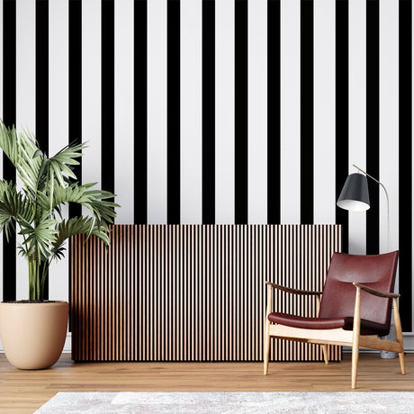 Black and white striped wallpaper creating height in modern living room with gray sofa