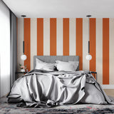 Home office featuring vertical orange stripes wallpaper making the ceiling appear higher