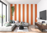 Dining room with bold orange striped wall mural adding warmth and sophistication