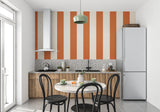 Children's playroom with cheerful orange stripe wall design making the space feel larger