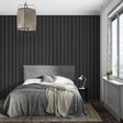 Modern black striped wallpaper in a minimalist living room showing vertical pattern impact