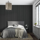 Modern black striped wallpaper in a minimalist living room showing vertical pattern impact
