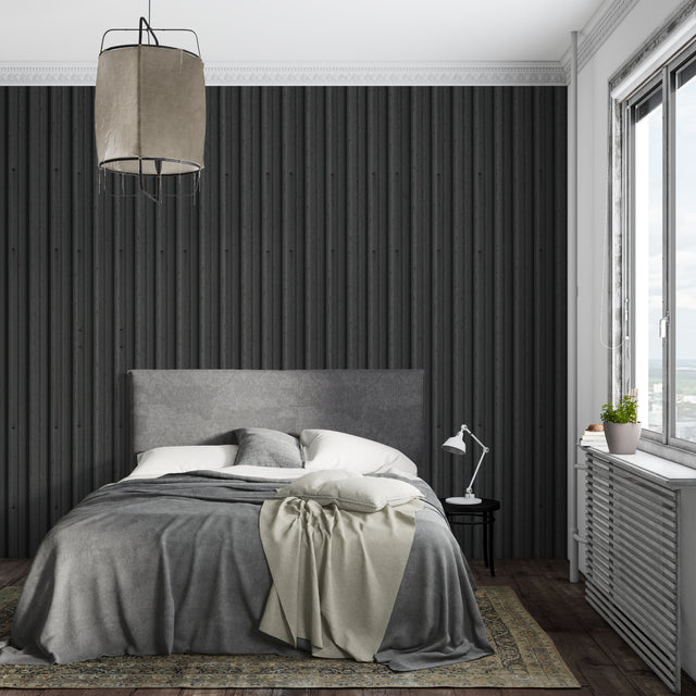Modern black striped wallpaper in a minimalist living room showing vertical pattern impact