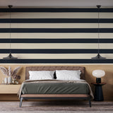 Modern navy blue striped wallpaper in a bright home office, creating a professional and clean backdrop for remote work
