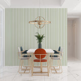 Sage green striped wallpaper in a bright modern living room, showing vertical pattern creating height