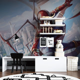 Superhero mural bringing action to kids playroom with blue accent wall