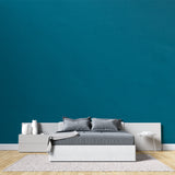 Contemporary office space with teal wallpaper mural creating focused atmosphere