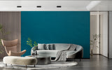 Minimalist bedroom featuring solid teal wall mural with natural light