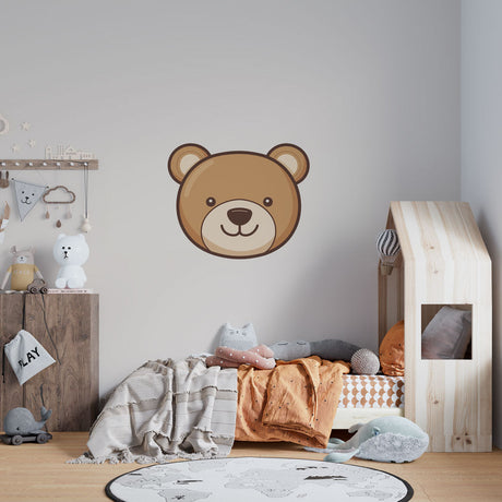 Teddy bear wallpaper creating a cozy atmosphere in a modern nursery with white furniture and natural light