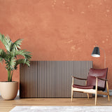 Textured terracotta wallpaper adding depth to minimal bedroom design