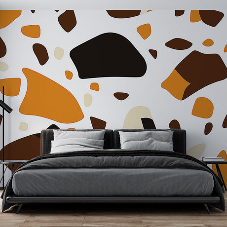 Modern Terrazzo Wallpaper with orange and brown pattern shown in a bright living room setting with minimal furniture