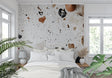 Modern terrazzo wallpaper in a bright living room, white and terracotta stone pattern adding texture to contemporary space