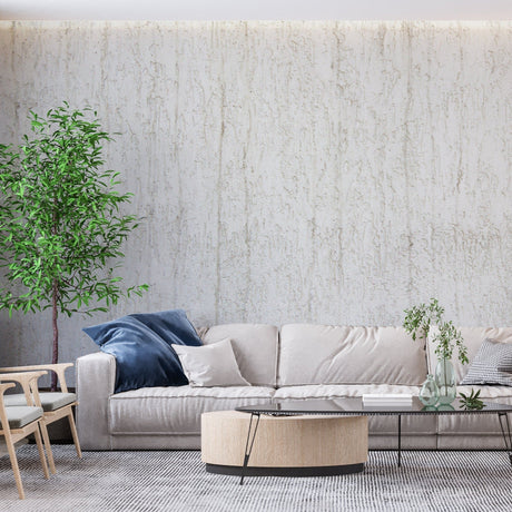 White relief pattern wallpaper in modern living room with natural light highlighting textural details
