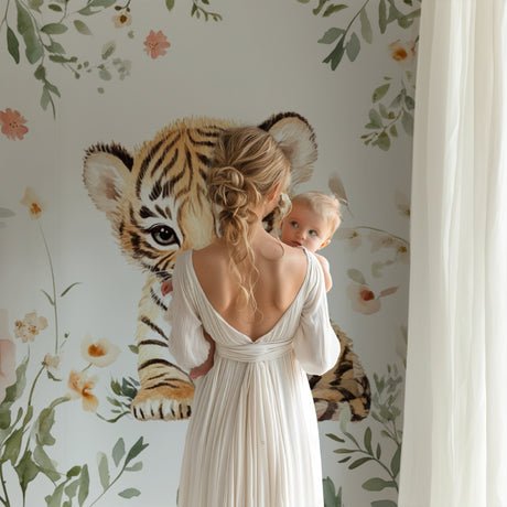 Tiger cub nursery wallpaper in a cozy pink nursery with white furniture and soft lighting