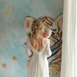 Tiger Cub Wallpaper in modern nursery with white furniture, showing soft blue tones and golden stars