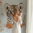 Baby Tiger Wallpaper creates a dreamy atmosphere in a modern nursery with soft natural lighting