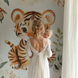 Tiger nursery wallpaper in modern white nursery with wooden crib and soft lighting