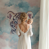 Kids bedroom featuring tiger wall mural, natural lighting highlighting the dreamy pastel colors