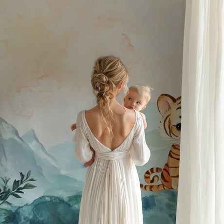 Baby tiger wallpaper mural styled in modern nursery with white furniture and soft textiles