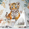 Tiger cub wallpaper in cozy nursery with white furniture and soft pink accents