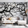 Black tree branch wallpaper creating dramatic impact in a modern living room with natural light and minimal furniture
