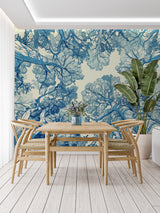 Blue botanical tree mural adding height to a cozy bedroom setting