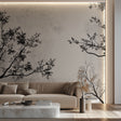 Black and white tree branch wallpaper creating depth in a modern living room setting