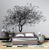 Black and white tree wallpaper creating a stunning focal point in a minimalist living room with modern furniture