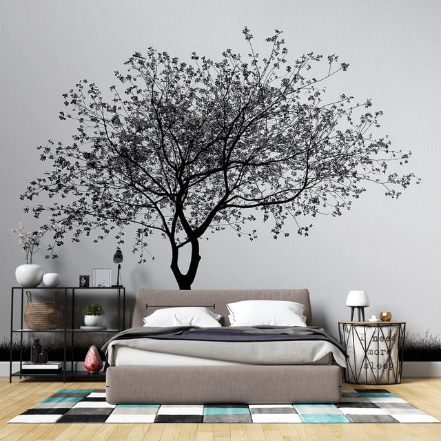 Black and white tree wallpaper creating a stunning focal point in a minimalist living room with modern furniture
