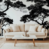 Black and white tree wallpaper creating drama in modern living room with grey sofa