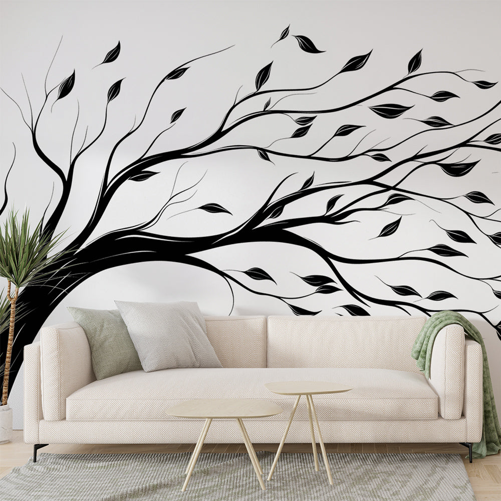Black and white tree wallpaper creating depth in a modern minimalist living room with natural light streaming through windows